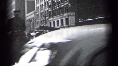 1937: marching band turns city corner while cars continue in opposite way