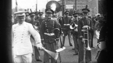 1937: twirler shows off skills in front of band members CLEVELAND OHIO