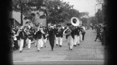 1937: An Uncolored Video Showing a Band Walk While Playing Instruments Such as