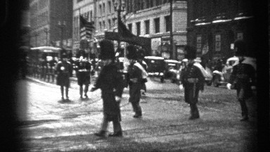 1937: a large group of soldiers is marching in formation down the street