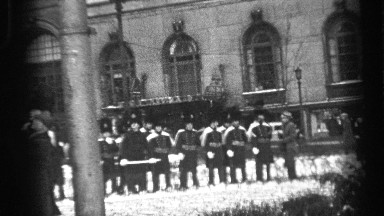 1937: a festival time people are grouped together and try to place the flag and