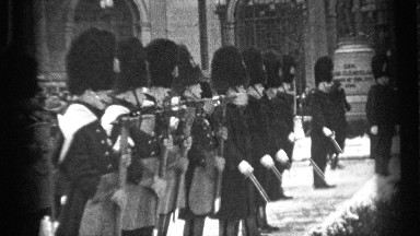 1937: an honor guard and a color guard dressed in uniform stand in formation