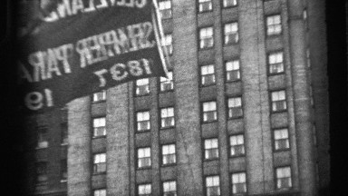 1937: waving flag being raised in front of multi story building CLEVELAND OHIO