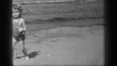 1938: a baby has toys and running from near the ocean and walking around at