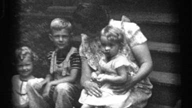 1938: woman sitting at front house steps with her children CLEVELAND OHIO