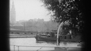 1938: a small ship moving at the water it looks like lake and air also released