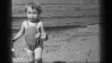 1938: a nice child playing near the sea at the beach on vacations CLEVELAND OHIO