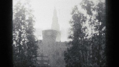 1938: a castle with a cathedral in the distance. panning across showing its