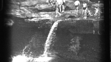 1938: people are going to take bath at a falls located at mountain near to a