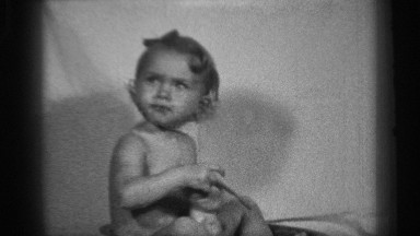 1938: a little cute baby having hey toy and watching somewhere and using the toy