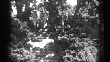 1938: young child between two women holds their hands descending park steps