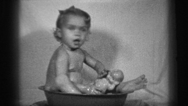 1938: young girl and her dolly bathing in old metal dish pan CLEVELAND OHIO