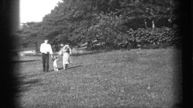 1938: mother and father walking hand and hand with their child CLEVELAND OHIO