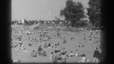 1939: at a festival a group of people at the ground and talking with each other