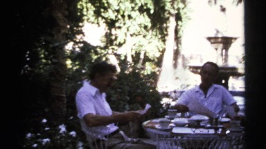1974: three people or family members are talking and having their tea at the