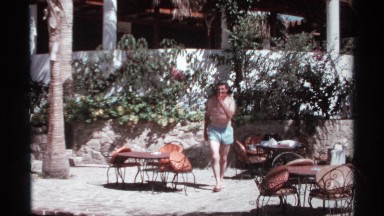 1974: man walks across patio, enters pool and starts to swim CABO SAN LUCAS