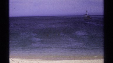 1974: a beautiful ocean and a boat or ship coming to the ocean corner and it