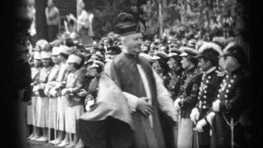 1937: leaders of the country walking in the center both side people standing in