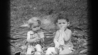 1937: children having a picnic on a blanket CLEVELAND OHIO