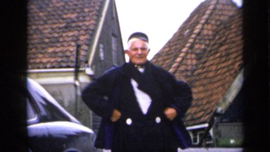 1957: Man Posing in Costume with Black Coat and Shoes