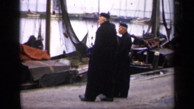 1957: older men visiting a port and observing the boats and landscape
