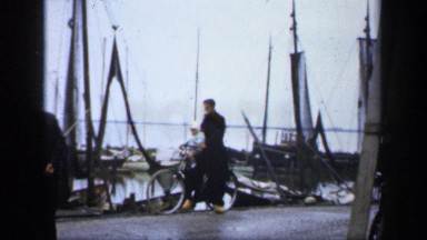 1957: man and a baby on a bicycle near docks NETHERLANDS