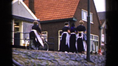 1957: ladies are walking out with uniform dresses and they may be go for work or