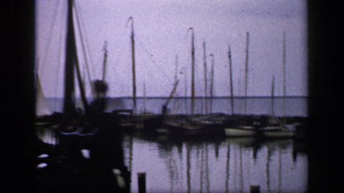 1957: a place of harbor and more boats are landing there at the water and men