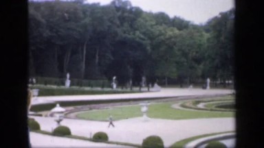 1957: a place of garden and people also walking there some trees and plant also