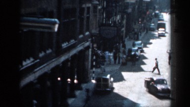 1957: At a City Road Men Are Walking and Some Vehicles Are Moving but Not a Rush