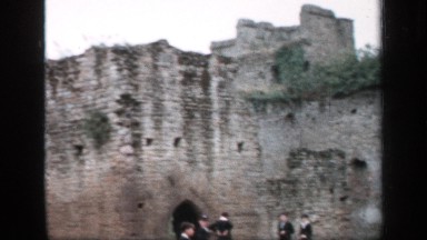 1957: people near an old building ENGLAND