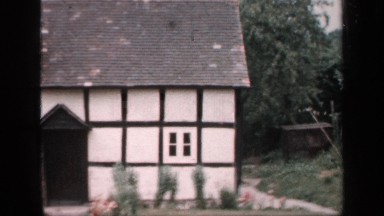 1957: country home has dark trim forming square pattern over pale outer wall