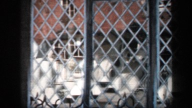 1957: camera panning a window and two plaques at a monument that is a birthplace