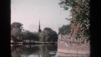 1957: a nature with water and surrounding trees and a building or pillar at long