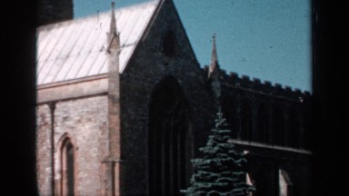1957: Silvery Evergreen Tree Stands in Front of Church and Behind Cemetery