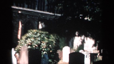 1957: images of graveyard on sunny day in the shade and full sun ENGLAND