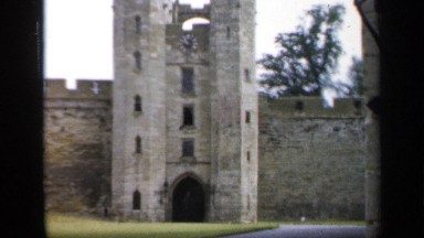 1957: views of a castle with high brick walls, trees, and a nice courtyard.