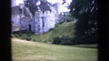1957: a building and a pillar near to it and some trees are near and top of the