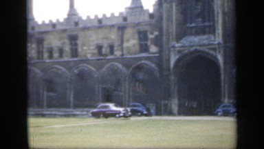 1957: camera pans right to left on old and weathered estate, with people and
