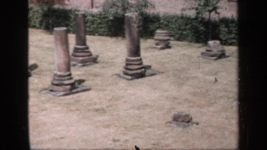 1957: two women pushing baby in stroller past a cemetery ENGLAND