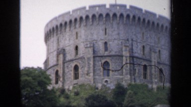 1957: large brick castle wooded area with large wall around it. ENGLAND