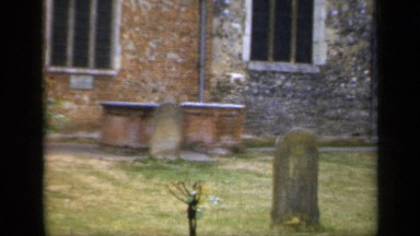 1957: a small cemetery with old headstones marked with age and years of wear