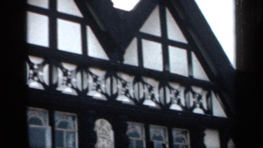 1957: an outside view of a building with many windows scanning from top to