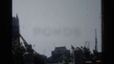 1957: two building are located little far at parallel and a bridge is used