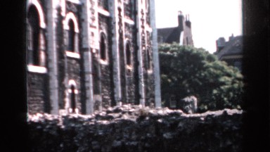1957: an old building surrounded by trees and other buildings ENGLAND