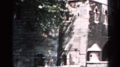 1957: a building with a tree near to it and a road backside available at the