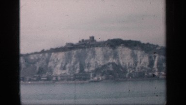 1957: quarry formed on the shore of the river with calm blue water ENGLAND