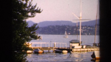 1957: Overlooking Bay with Boats Docked and Moving in England