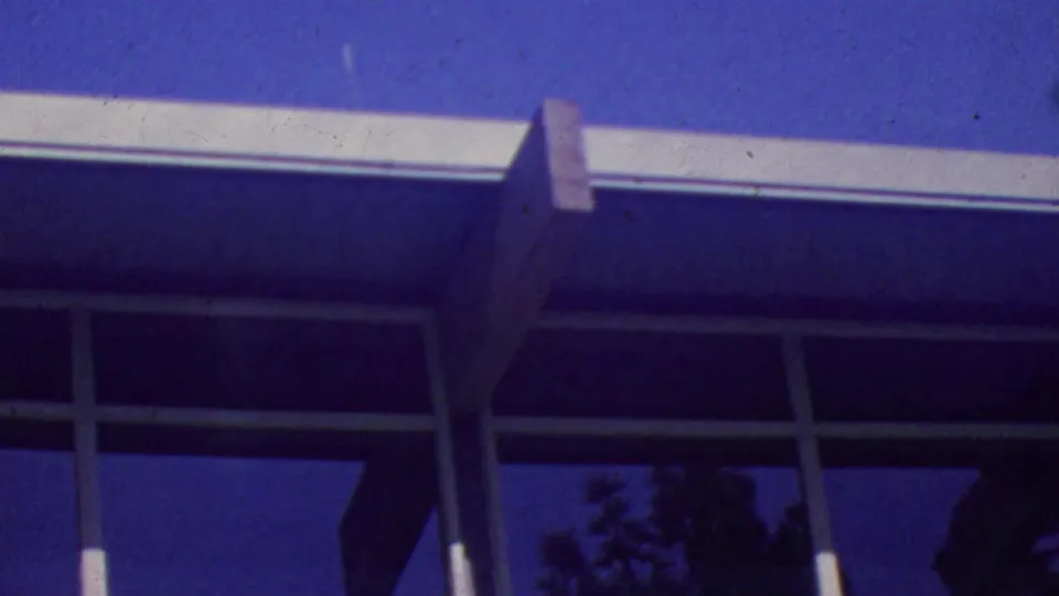 The final frame shifts toward the Palm Springs Aerial Tramway building exterior, showing blue sky, roofline, structural supports, and dark reflective windows.