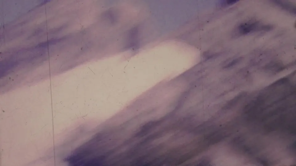 A soft, motion-blurred end frame from the 1964 Palm Springs tramway footage, showing light and shadow with visible grain and scratches.